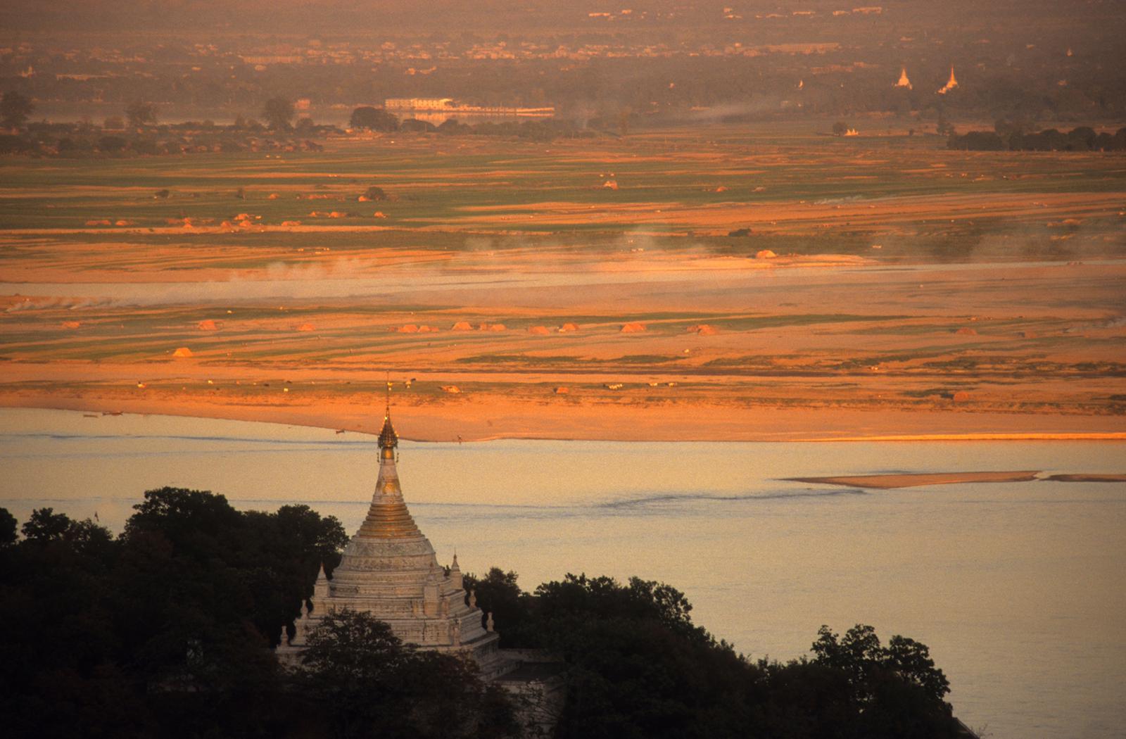The sun rises over Sagaing Hill and the Irrawaddy River in the Dry Zone.