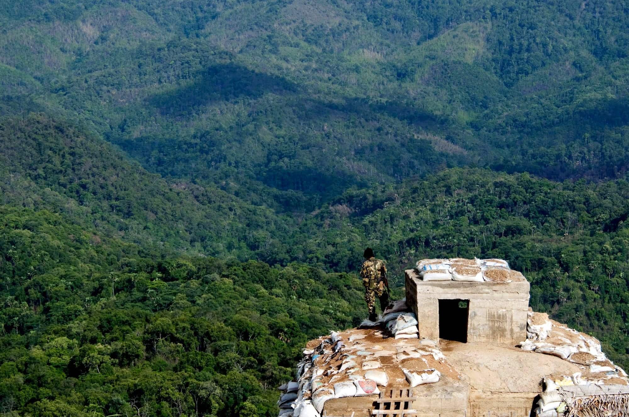 A soldier of the Shan State Army – South, the armed wing of the Restoration Council of Shan State, stands atop a sentry post in the Shan Hills in 2010 (Thierry Falise via Getty Images)